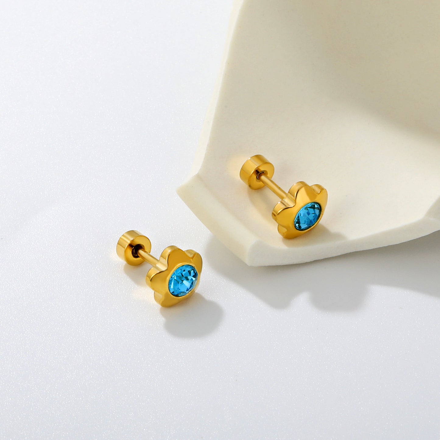 Aqua Flower gold earrings flat lay – 18K gold plated by Twisty Locks