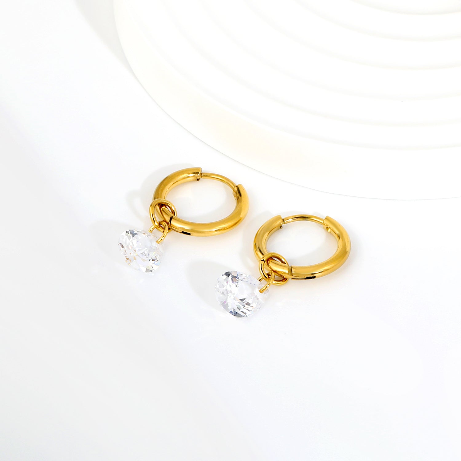 Pear Solitaire Hoops flat lay – 18K gold plated by Twisty Locks