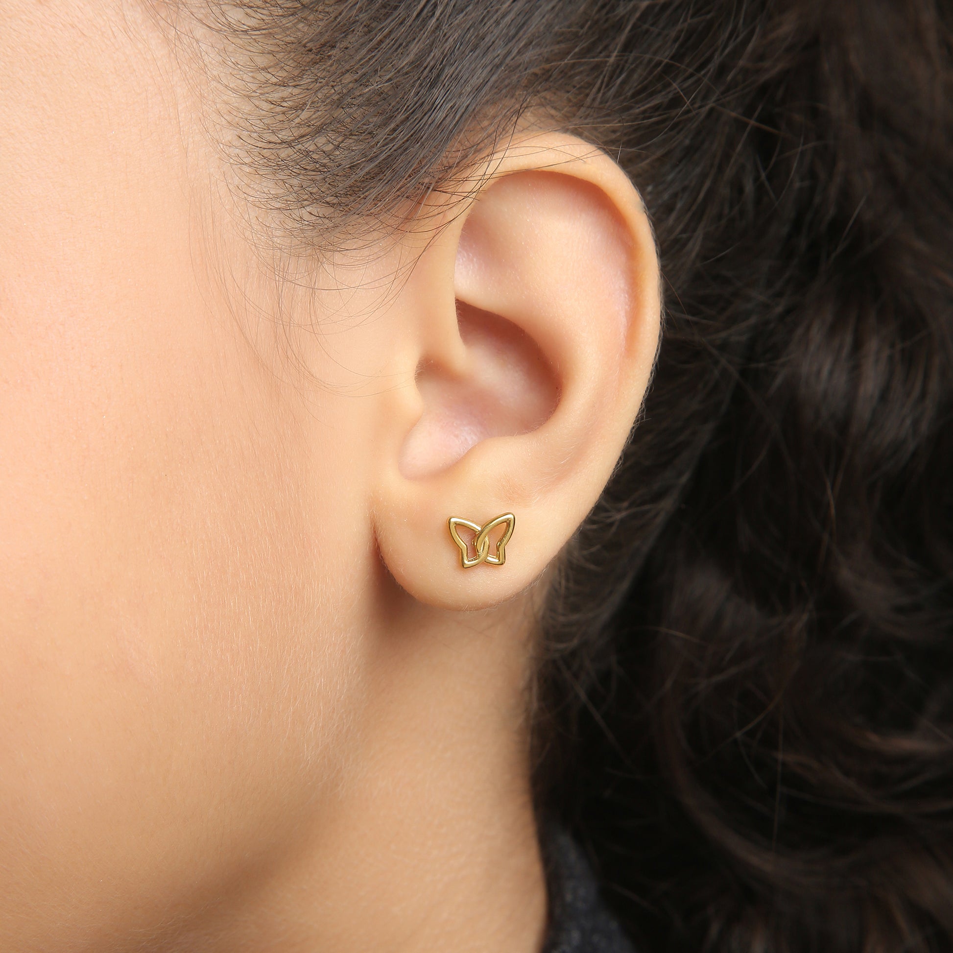 Butterfly Knot gold earrings on model – kids jewellery by Twisty Locks